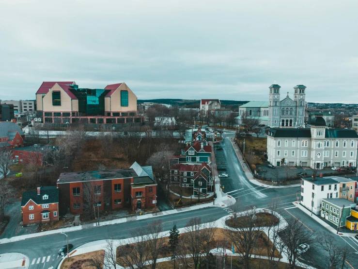 a view of a city from the top of a building, by Brian Snøddy, pexels contest winner, visual art, quebec, small town surrounding, drone footage, old abbey in the background