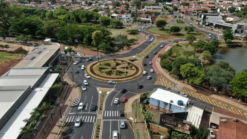 a city filled with lots of traffic next to a river, by Willian Murai, pexels contest winner, ornamental halo, intersection, reunion island, public art
