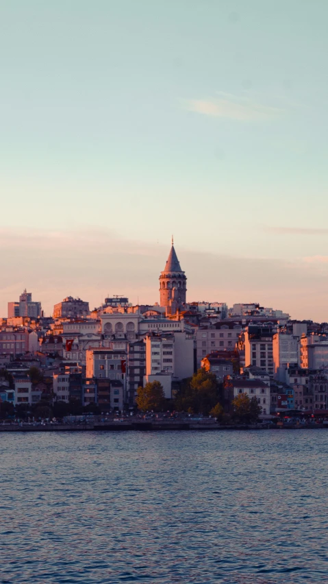 a large body of water with a city in the background, by Cafer Bater, pexels contest winner, turkey, slide show, golden hour photo, kingslanding