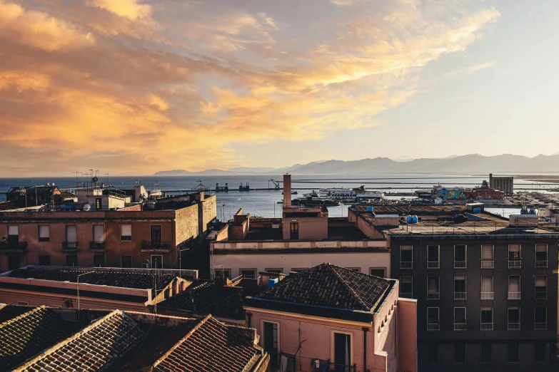 a view of a city from the top of a building, pexels contest winner, romanticism, gulf of naples, golden hour hues, profile image, ultrawide lens”