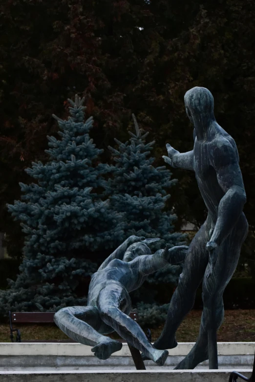 a man sitting on a bench next to a statue, a statue, by Slava Raškaj, unsplash, new sculpture, adam and eve, fighting scene, lit from the side, low quality photo