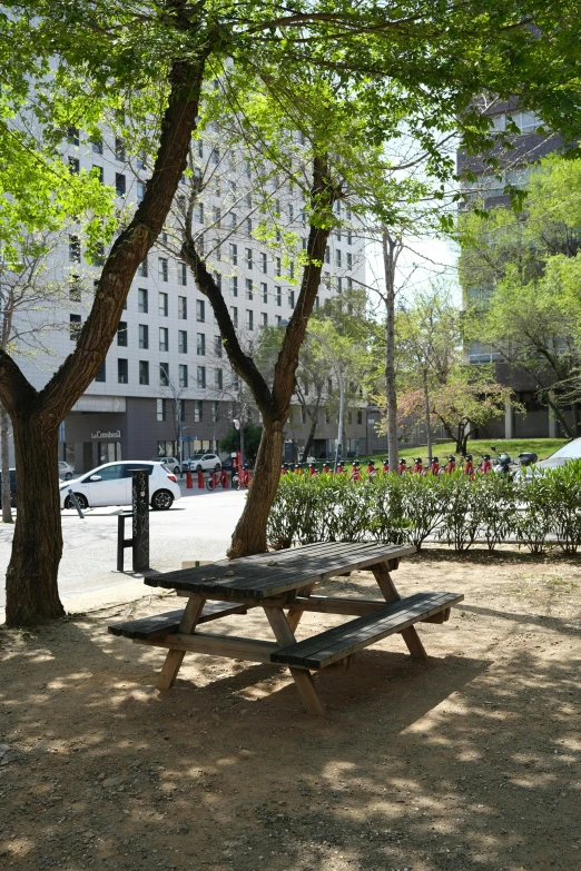 a picnic table sitting in the middle of a park, by Arthur Sarkissian, downtown mexico, well shaded, in barcelona, set in tokyo bank parking lot