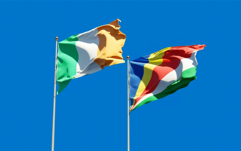 two flags blowing in the wind against a blue sky, inspired by Juan O'Gorman, renaissance, multicoloured, obunga, thumbnail, high quality image”