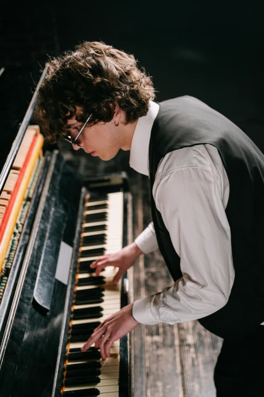 a man in a vest playing a piano, an album cover, unsplash, bauhaus, finn wolfhard, 15081959 21121991 01012000 4k, profile picture, steamy