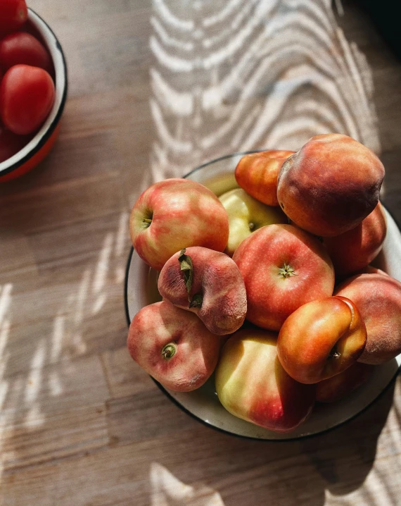 a bowl of apples sitting on top of a wooden table, glowing peach face, thumbnail, tomatoes, uncropped