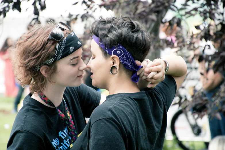 a couple of women standing next to each other, a photo, flickr, wearing a bandana and chain, lesbian kiss, mowhawk, supportive