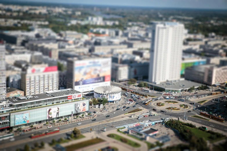 a city filled with lots of tall buildings, a tilt shift photo, by Adam Marczyński, unsplash contest winner, photorealism, stadium, фото девушка курит, square, warsaw