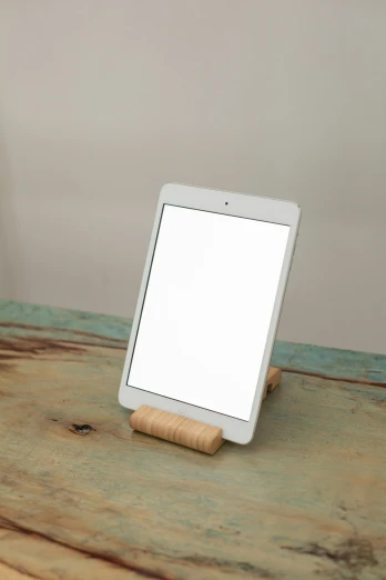 a tablet computer sitting on top of a wooden table, inspired by Isamu Noguchi, computer art, 3/4 front view, birch, bright white light, smol
