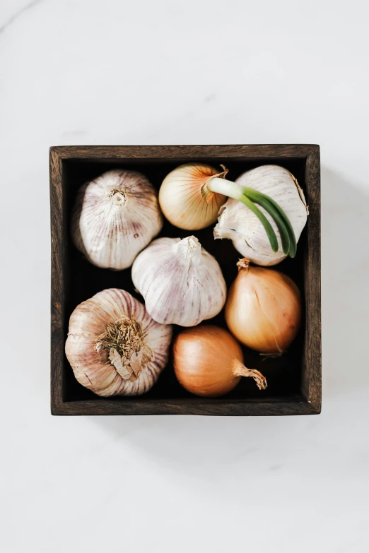 a wooden box filled with onions and garlic, curated collection, square, f / 2 0, medium portrait