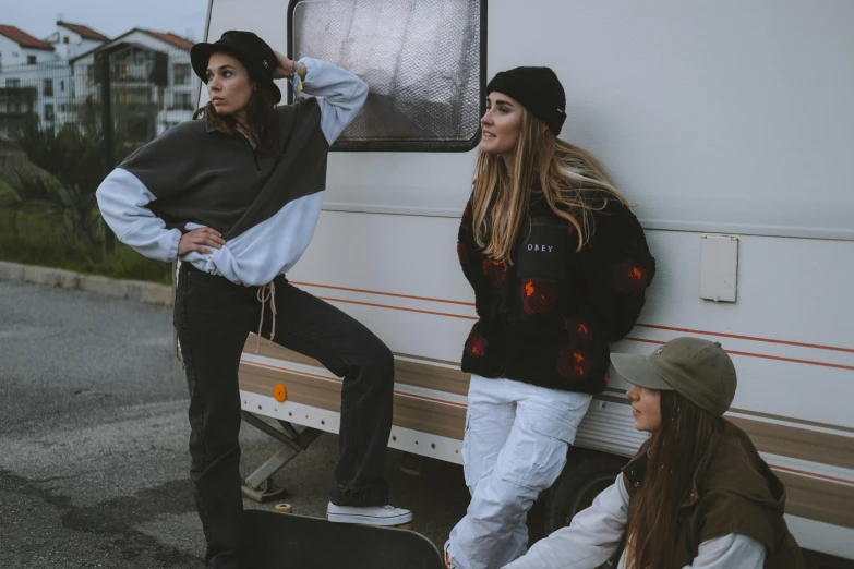 a couple of women standing next to a camper, trending on pexels, street wear, three women, sitting down, shot from movie