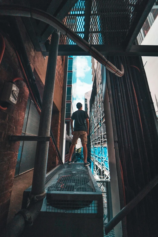 a man walking up a set of stairs, by Niko Henrichon, pexels contest winner, scaffolding, in chippendale sydney, looking out, gif