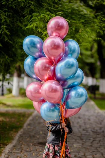 a little girl holding a bunch of balloons, by Doug Ohlson, unsplash, mauve and cinnabar and cyan, metallic reflective, made of cotton candy, mother of pearl iridescent