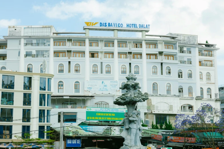 a large white building with a fountain in front of it, by Ellen Gallagher, vietnam, capsule hotel, background image, square