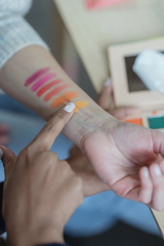 a close up of a person putting lipstick on a person's wrist, process art, medical labels, rainbow colored, square, synthetic bio skin