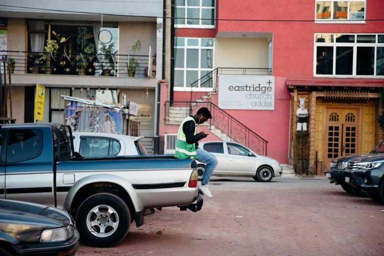 a person riding a scooter on a city street, an album cover, by Lee Loughridge, trending on unsplash, happening, ethiopian, green pickup car, sittin, westside