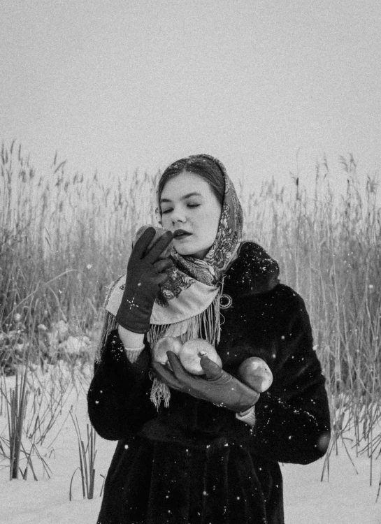 a woman standing in the snow holding a teddy bear, a black and white photo, inspired by Vasily Perov, she is eating a peach, sovietwave aesthetic, in a wheat field, 2 0 5 0 s