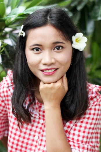 a woman with a flower in her hair, inspired by Ruth Jên, happening, smiling at camera, 21 years old, square, high-quality photo