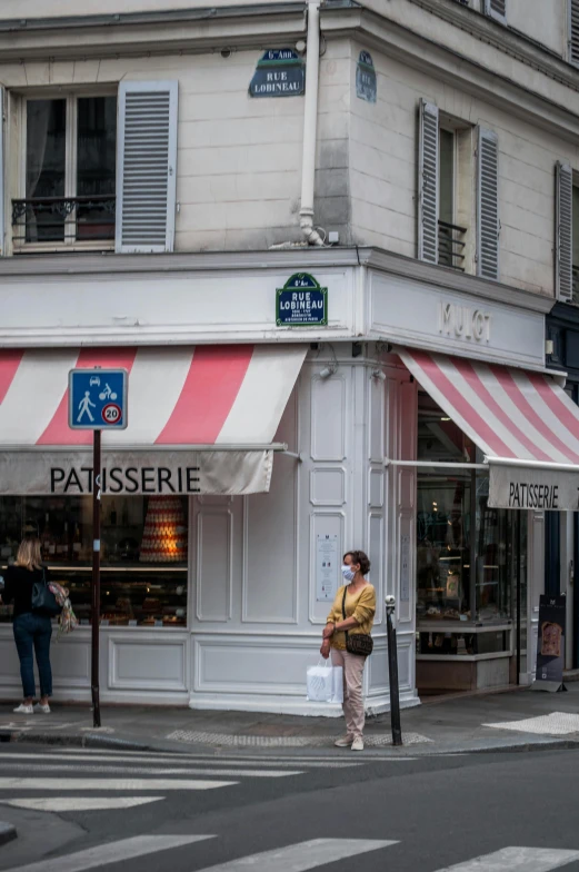 a group of people crossing a street in front of a store, art nouveau, pastries, pastelle, photograph taken in 2 0 2 0, awnings