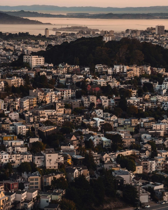 a view of a city from the top of a hill, by Carey Morris, unsplash contest winner, sf, lgbtq, high angle close up shot, multiple stories