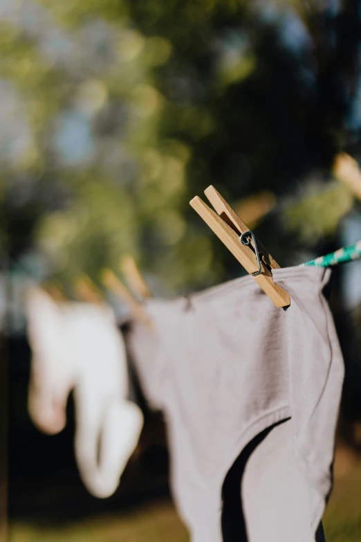 a pair of underwear hanging on a clothes line, pexels contest winner, wearing a grey robe, sustainability, hoses, having fun in the sun