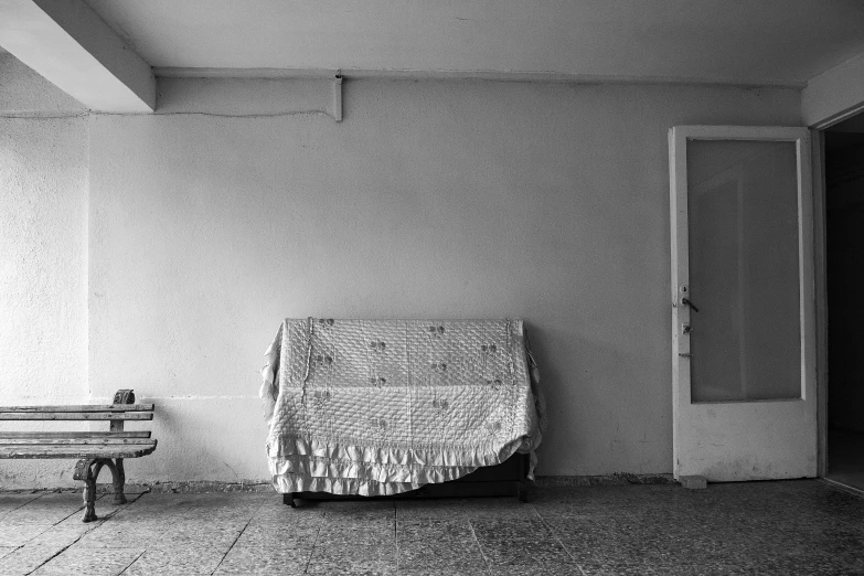 a black and white photo of a couch and a bench, inspired by Thomas Struth, quilt, cristi balanescu, abandoned photograph, covered!!