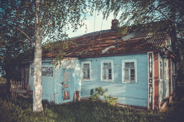 a blue house sitting in the middle of a field, a colorized photo, inspired by Isaac Levitan, pexels contest winner, soviet interior, faded glow, old shops, midsommar style