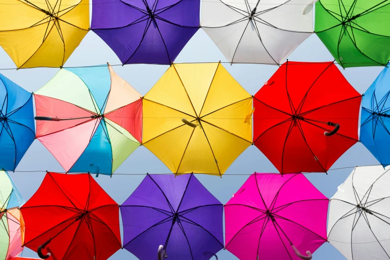 a bunch of colorful umbrellas hanging from a line, trending on unsplash, precisionism, rectangle, multiple stories, symmetrical image, canopies