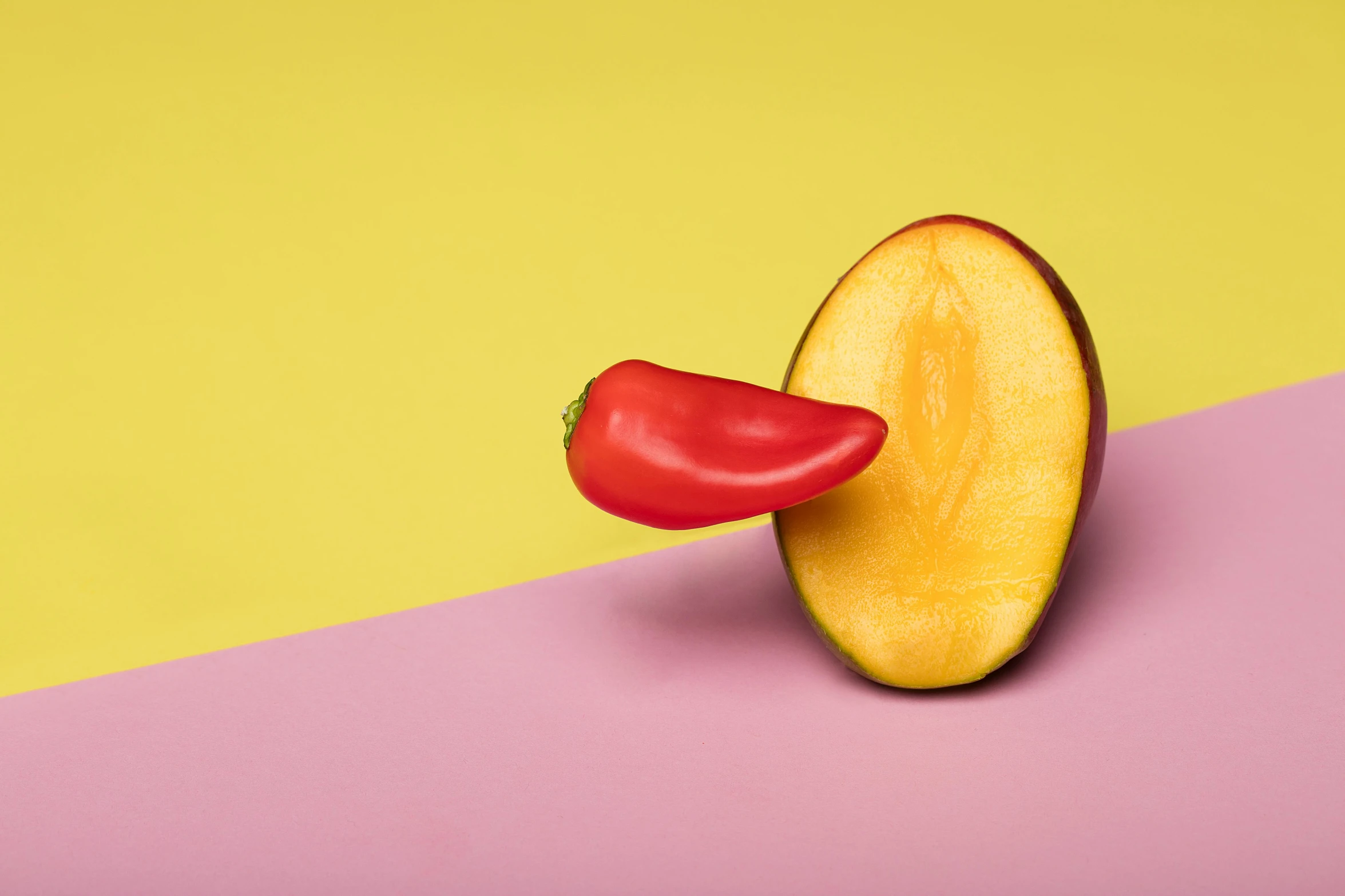 an apple slice with a tomato sticking out of it, a still life, inspired by Stanton Macdonald-Wright, trending on pexels, toucan, pepper, pink and yellow, spicy