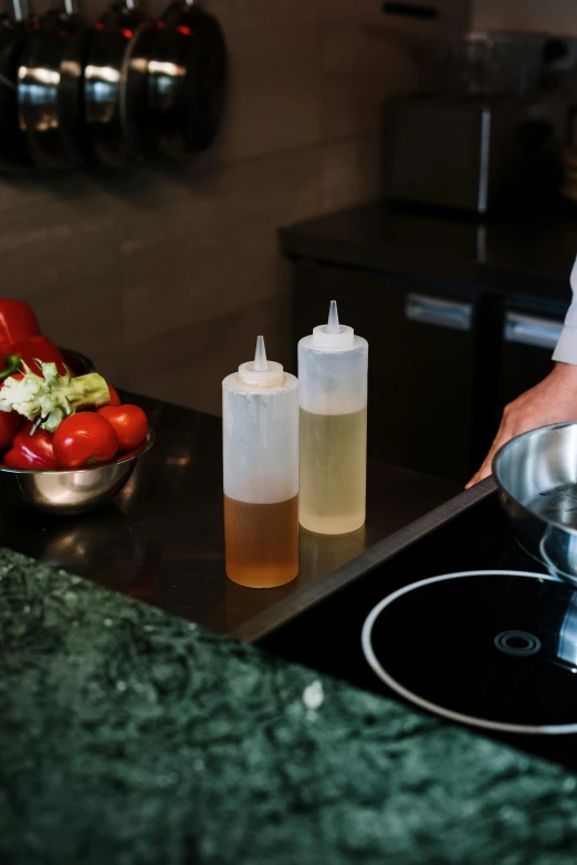 a person in a kitchen preparing food on a stove, holding hot sauce, detailed product image, salad, paul barson