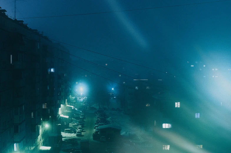 a street filled with lots of traffic next to tall buildings, inspired by Elsa Bleda, blue - turquoise fog in the void, magical soviet town, atmospheric lighting - n 9, chillhop