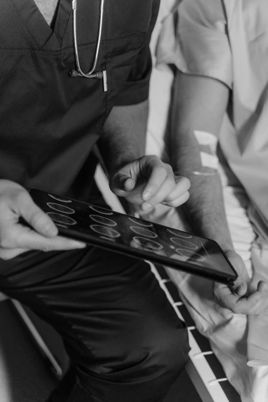 a black and white photo of a doctor and a patient, pexels, process art, holding controller, rhythm, medium close up, inspect in inventory image