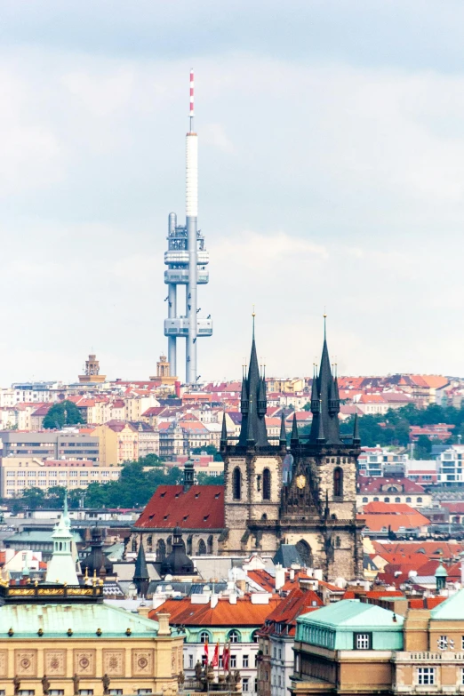 a view of a city from the top of a hill, by Adam Marczyński, pexels contest winner, renaissance, lead - covered spire, prague in the background, space elevator, high resolution photograph