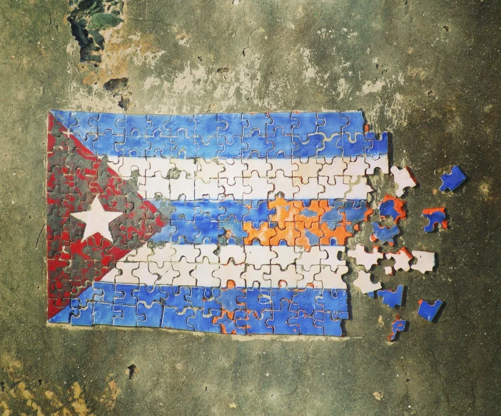 a puzzle piece with the flag of cuba painted on it, a jigsaw puzzle, by david rubín, graffiti, alessio albi, ffffound, flatlay, trash polka