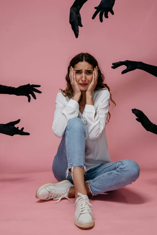 a woman sitting on the ground surrounded by silhouettes of hands, a cartoon, trending on pexels, antipodeans, scary angry pose, pastel', studio photo, plain background