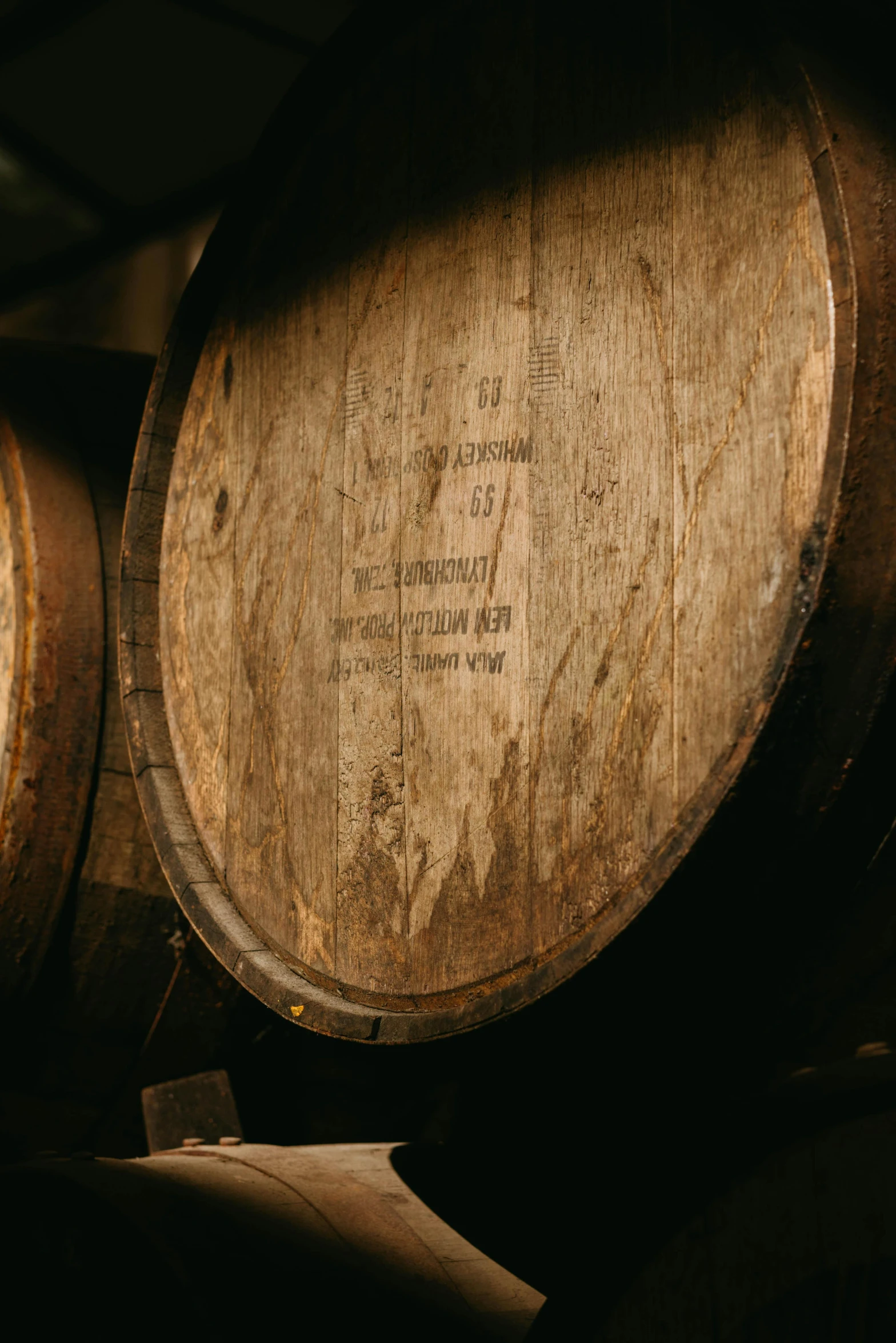 a couple of wooden barrels sitting next to each other, up-close, downward somber expression, uncrop, digital image