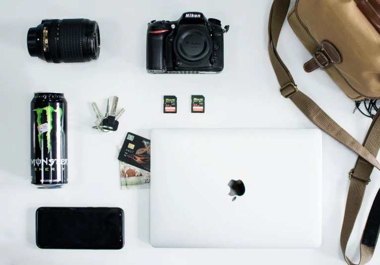 a bag sitting on top of a table next to a laptop, a picture, trending on pexels, minimalism, with nikon cameras, knolling, cinematic. white, full product shot