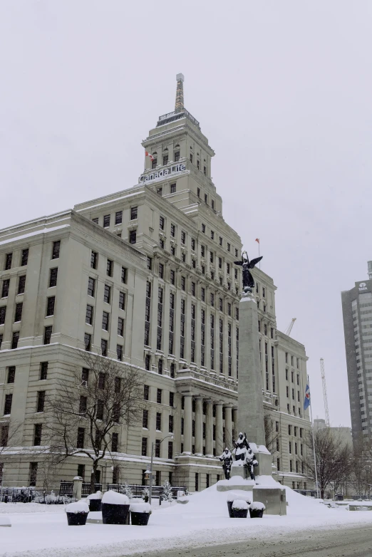 a large building with a clock tower on top of it, a statue, inspired by Yves Tanguay, severe snow, toronto city, video, thumbnail