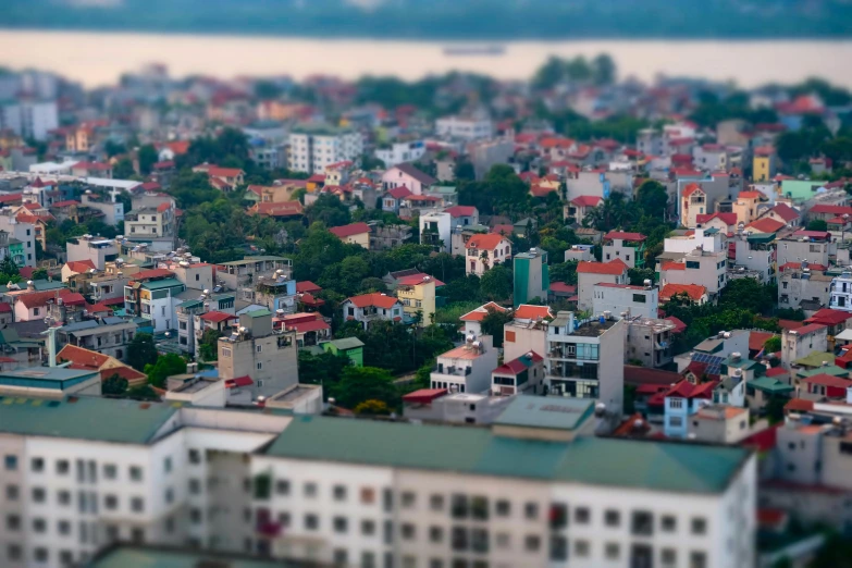 a view of a city from the top of a building, a tilt shift photo, pexels contest winner, photorealism, vietnam, sharp focus on houses, medium closeup, where a large