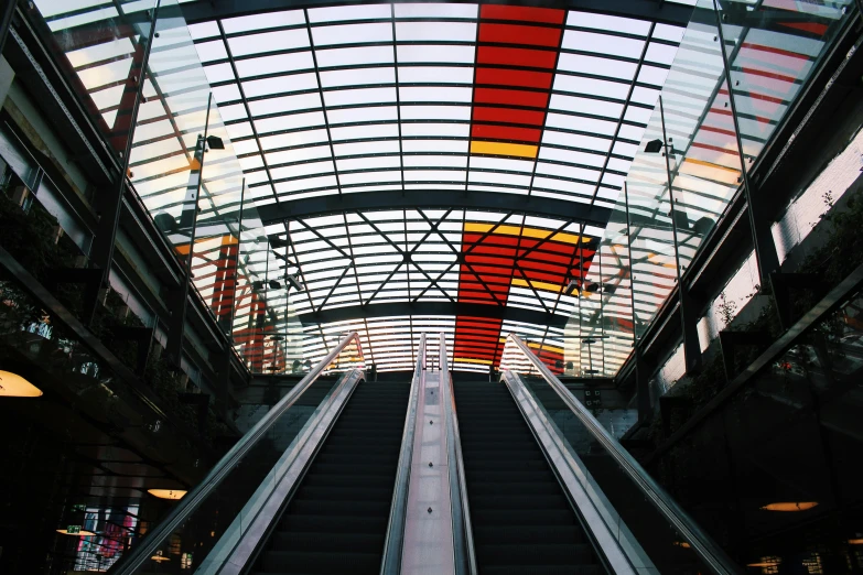 a close up of an escalator in a building, an album cover, pexels contest winner, bauhaus, giant red led screens, orange roof, 2 5 6 x 2 5 6 pixels, swiss modernizm