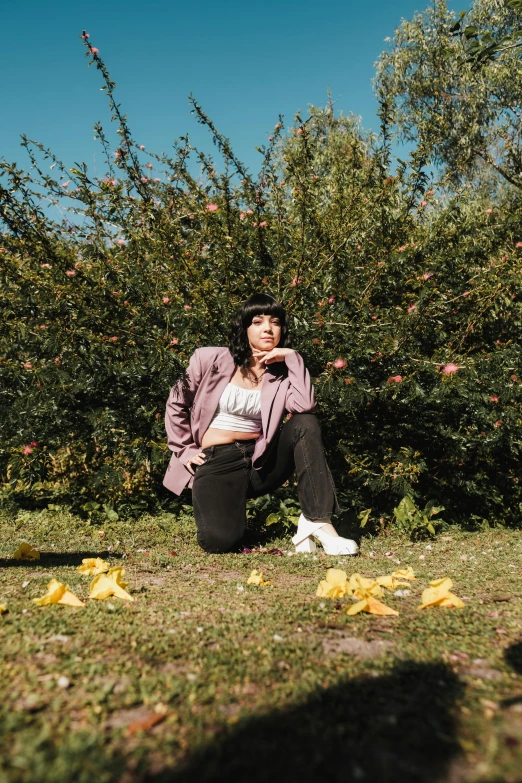 a woman sitting on the ground next to an apple tree, an album cover, pexels contest winner, charli xcx, lily frank, 15081959 21121991 01012000 4k, wearing jacket