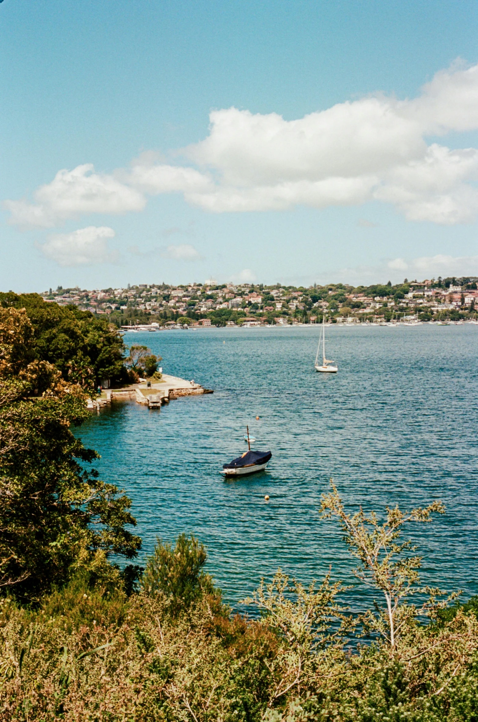 a couple of boats that are in the water, inspired by Sydney Carline, pexels, long shot kodak portra 4 0 0, panorama distant view, a quaint, overlooking