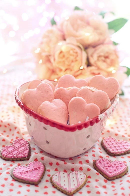 a bowl of cookies sitting on top of a table, by Elaine Hamilton, shutterstock contest winner, romanticism, soft light 4 k in pink, hearts, swedish, soft blush