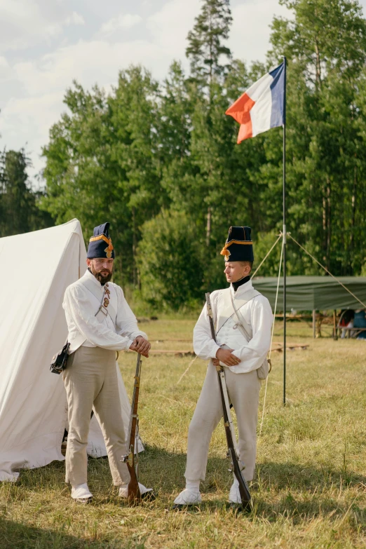 a couple of men standing next to each other in front of a tent, inspired by Édouard Detaille, unsplash, general uniform, live-action archival footage, summer season, french