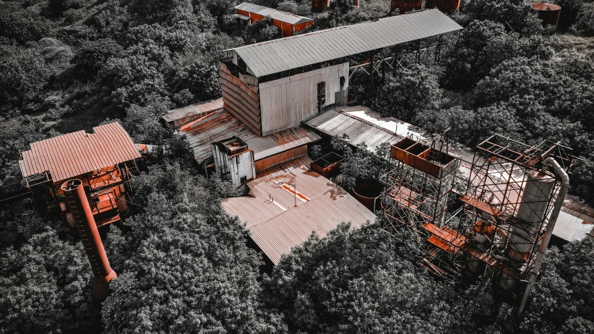 an aerial view of a building surrounded by trees, pexels contest winner, photorealism, rusted junk, chairlifts, desaturated, soviet yard