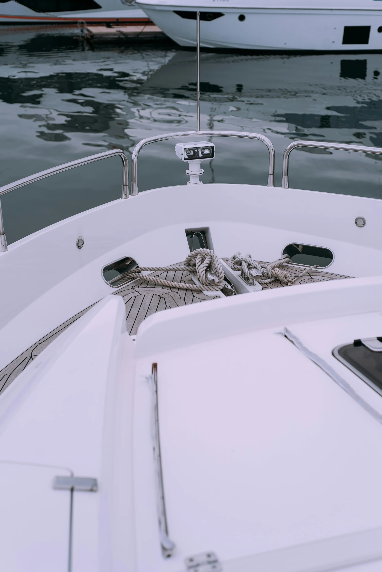 a close up of a boat on a body of water, happening, on the bow, cockpit, white mechanical details, low quality photo