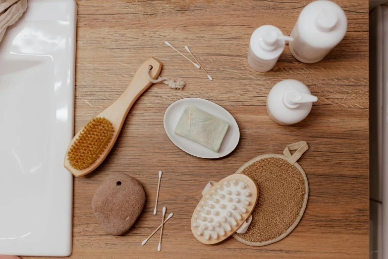 a white sink sitting next to a wooden counter top, a still life, by Andries Stock, unsplash, process art, photoshoot for skincare brand, dry brushing, floating objects, with intricate details