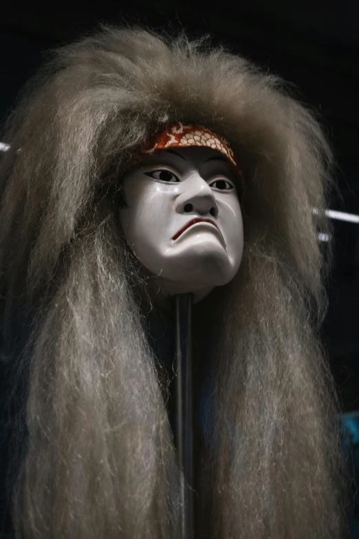 a close up of a mannequin with long hair, inspired by Shunkōsai Hokushū, mingei, tribal mask, jordan peele's face, furry face, museum item