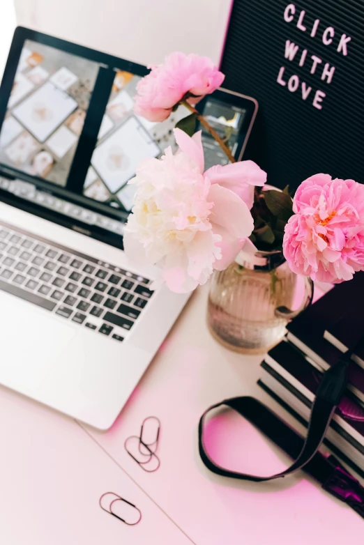 a laptop computer sitting on top of a pink desk, trending on pexels, romanticism, black peonies, instagram picture, multiple stories, floral couture