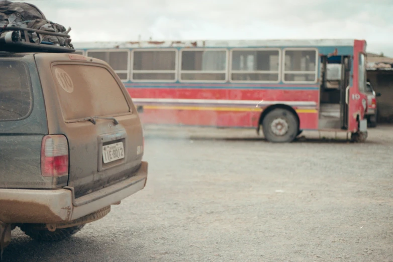 a van with luggage on top of it in a parking lot, by Carey Morris, pexels contest winner, visual art, detailed smoke and dust, abandoned bus stop, cinestill 800t 50mm eastmancolor, movie still of a tired