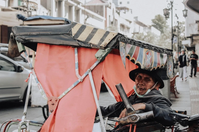 a man riding on the back of a motorcycle down a street, by Daniel Lieske, trending on unsplash, renaissance, bolivian cholitas, old mexican magician closes eyes, carriage, an old lady with red skin